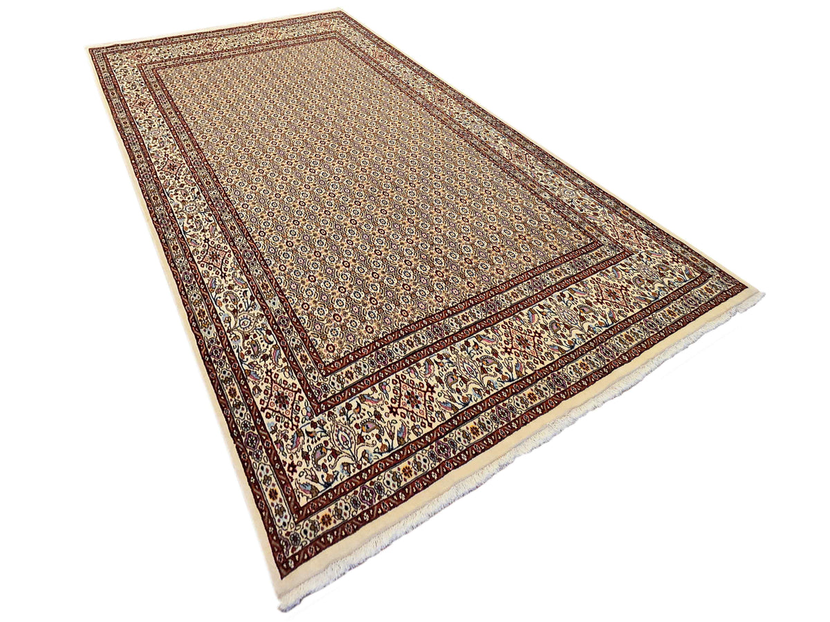 Persian rug angled view with ivory center medallions, rust red frame, and fringed edges