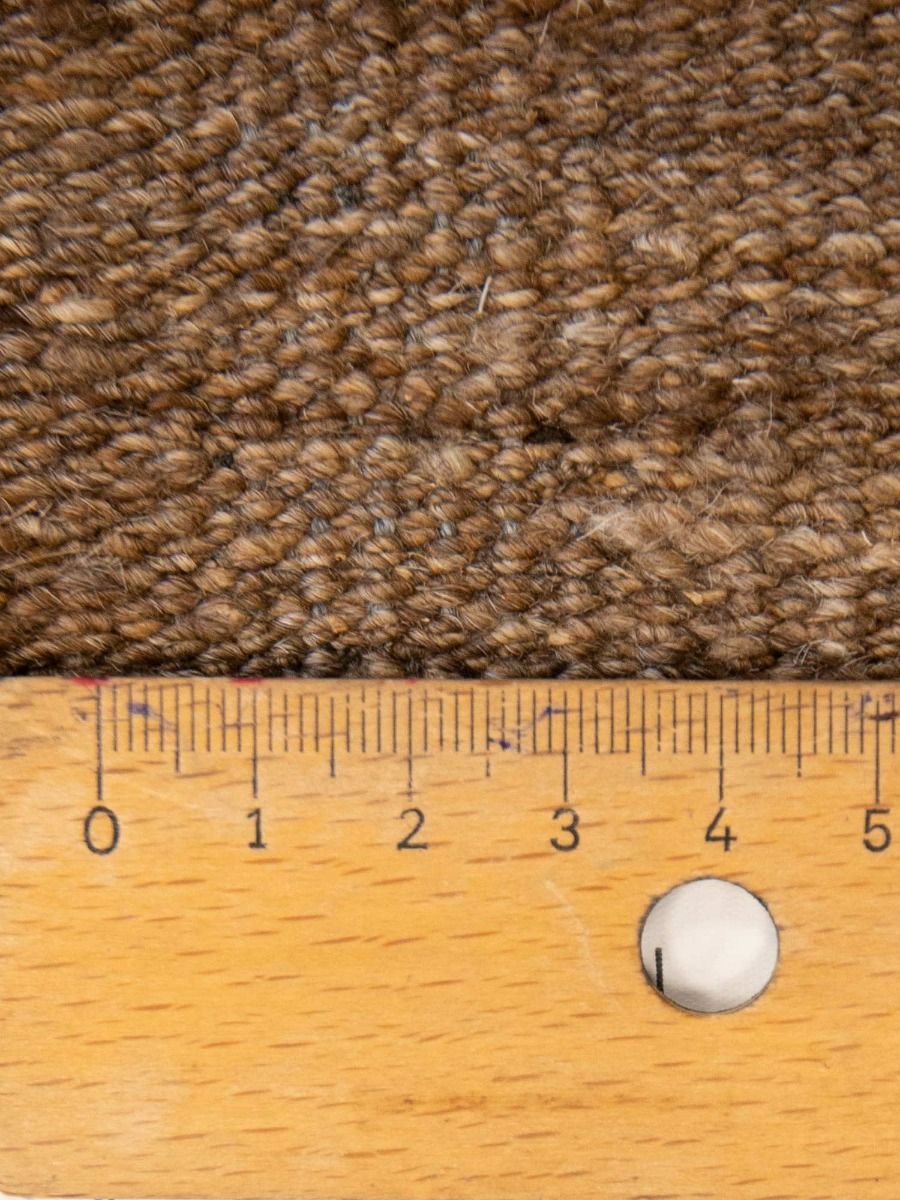 Brown and beige flatweave rug texture with tightly looped pile