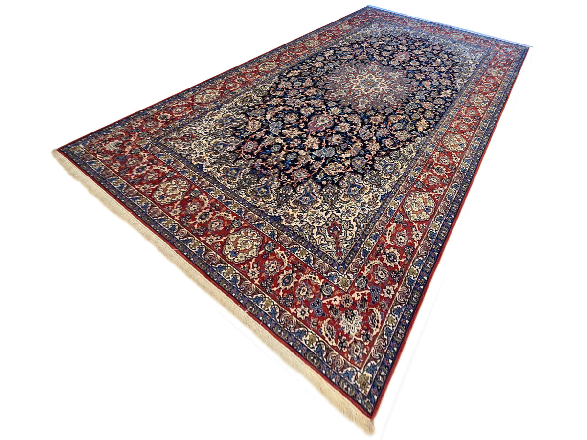 Persian-style rug with dark center medallion and red border, cream fringe visible