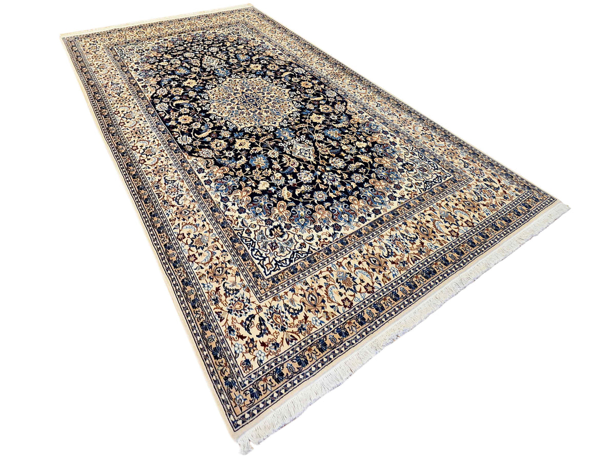 Nain rug with navy and cream field, ornate medallion panel and patterned border.