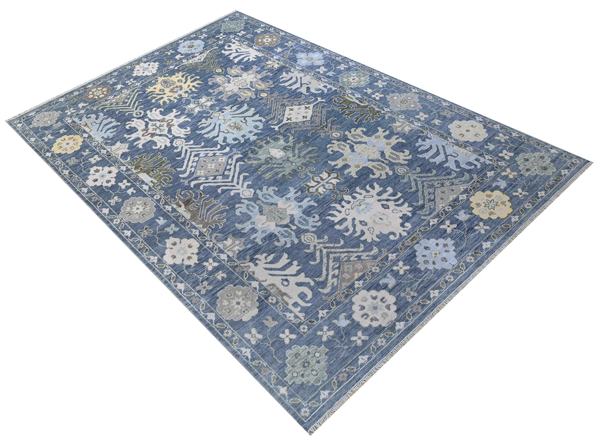 Oushak rug in blue with ornate floral geometric medallion pattern, rectangular flat lay