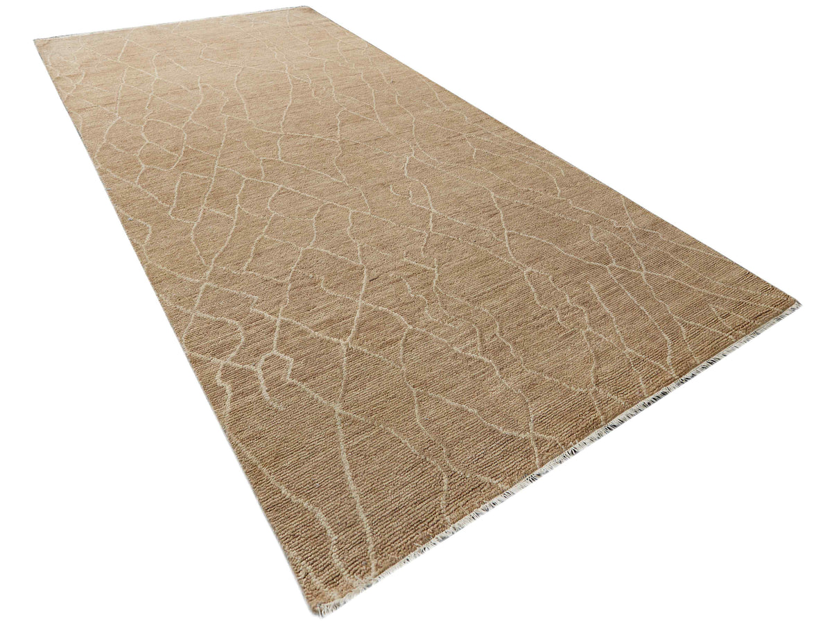 Beige crackle design rug with stitched border, diagonal view