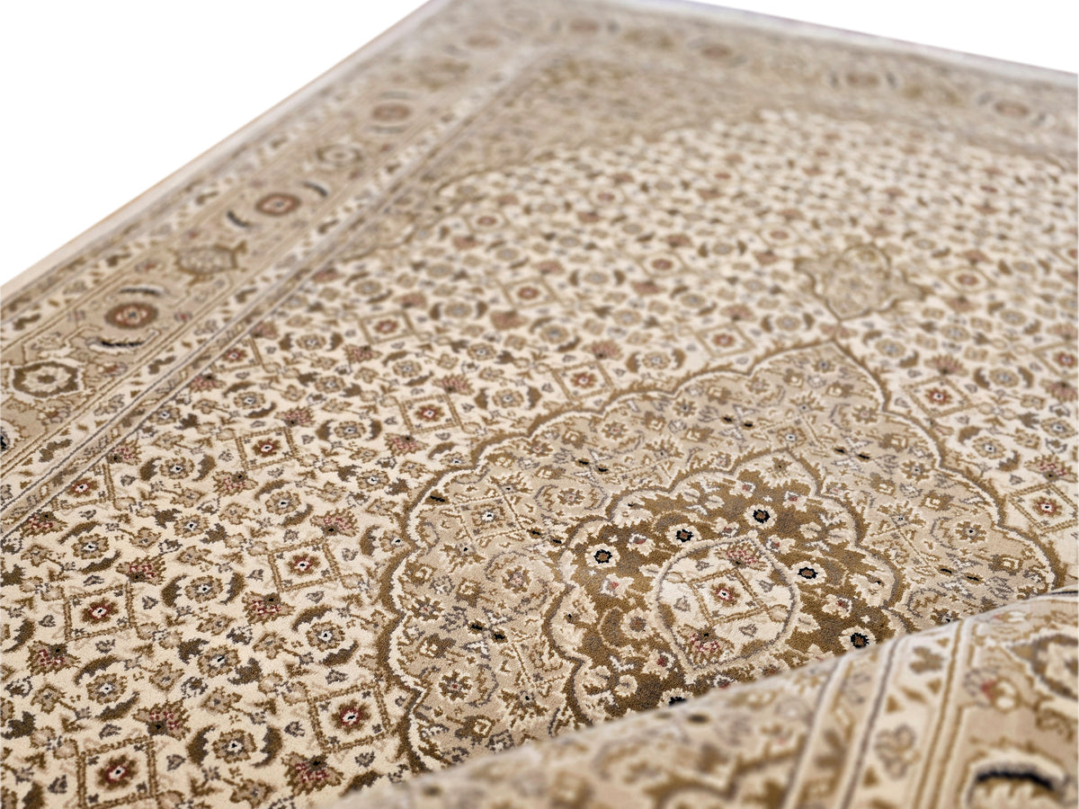 Rug surface close-up with beige background, dark motifs, and central medallion outline.