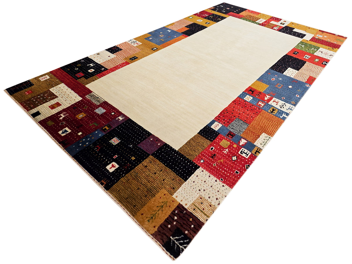Patchwork rug with cream field and multicolor quilt-like corner bands