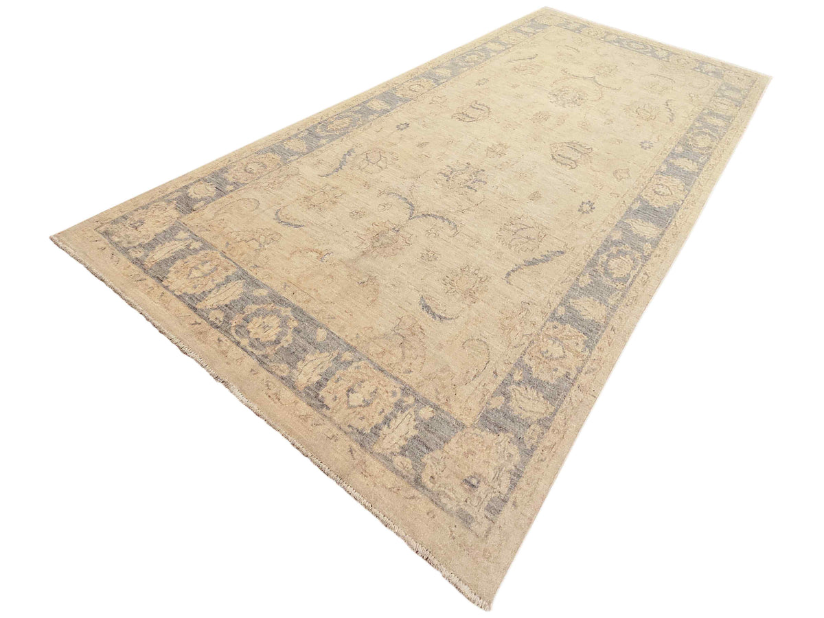 Beige and light blue Persian-style area rug with wide border and central motifs