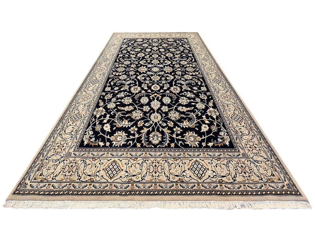 Navy Nain rug with cream ornamental border, center floral pattern, short fringe edge