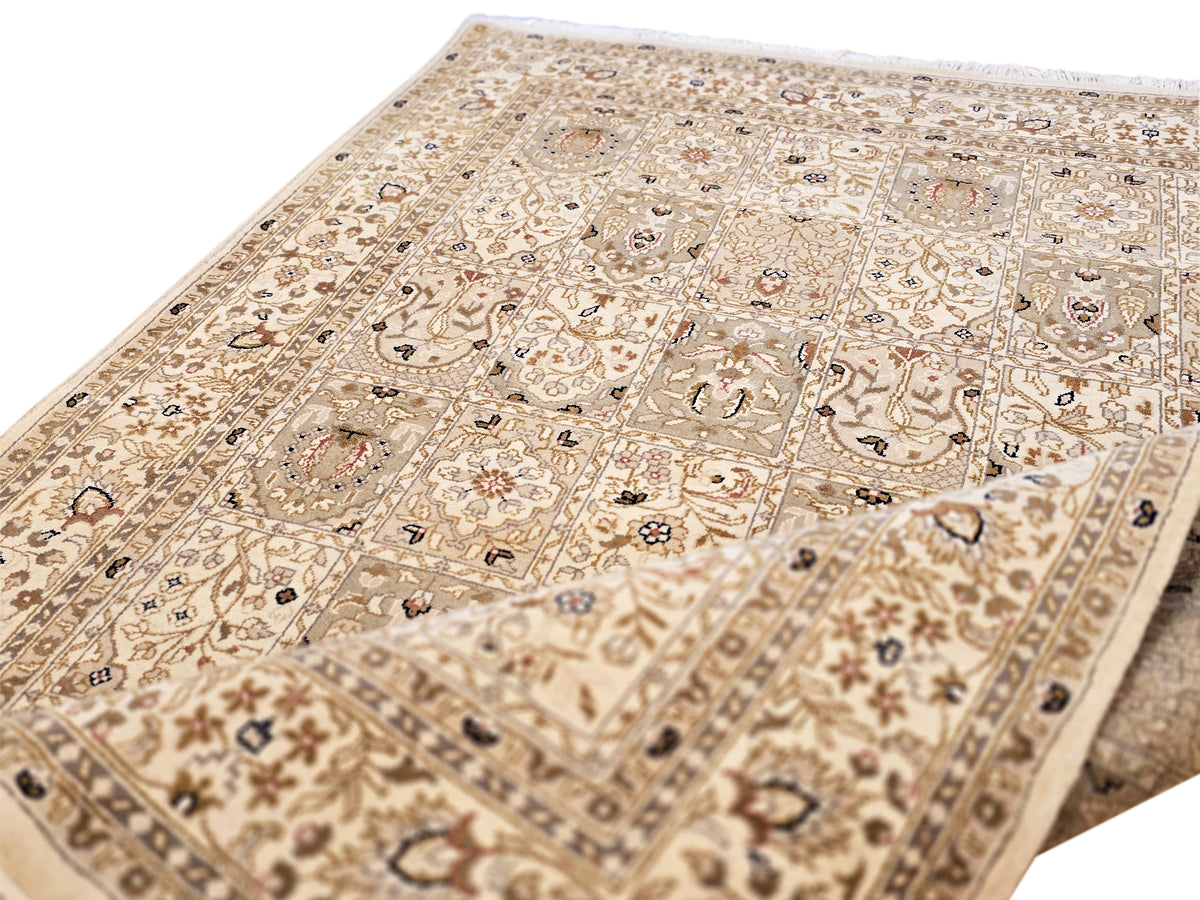 Bakhtiar rug surface view with beige pattern grid, small motifs, and fringed border corner.