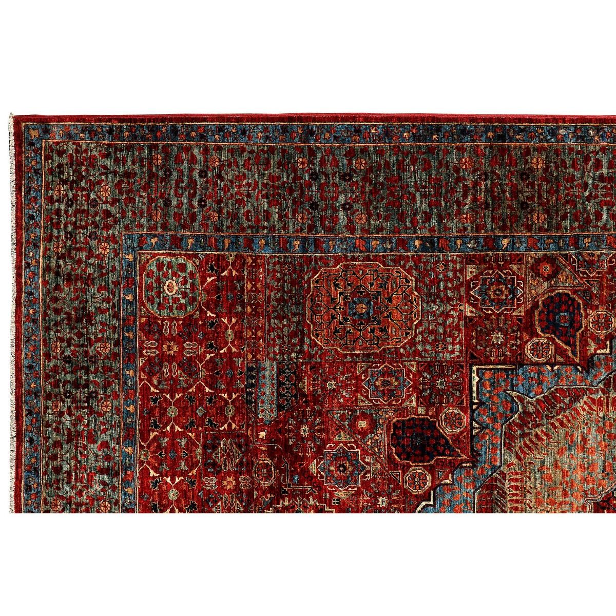 Multicolor patterned area rug with dense motifs and ornate border on a red ground