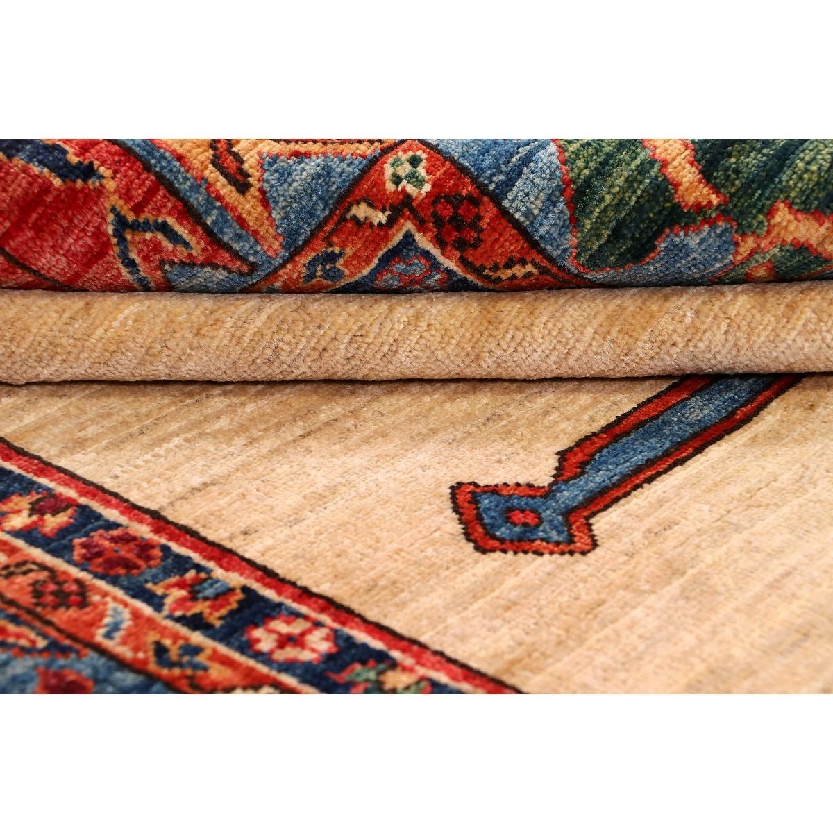 Rug edge close-up with cream field and red-and-blue border pattern strip.