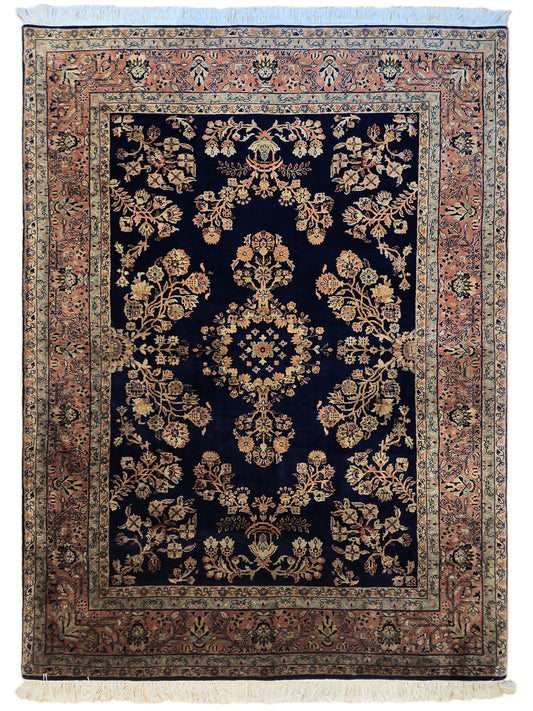 Sarouk rug with dark navy floral pattern, rust side border, light blue outer frame