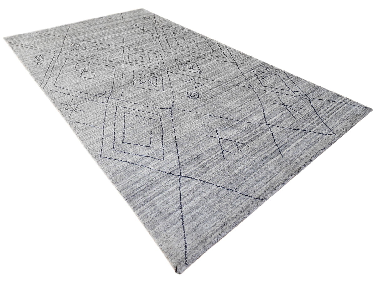 Gray rug with diamond geometry linework and scattered small motif outlines.