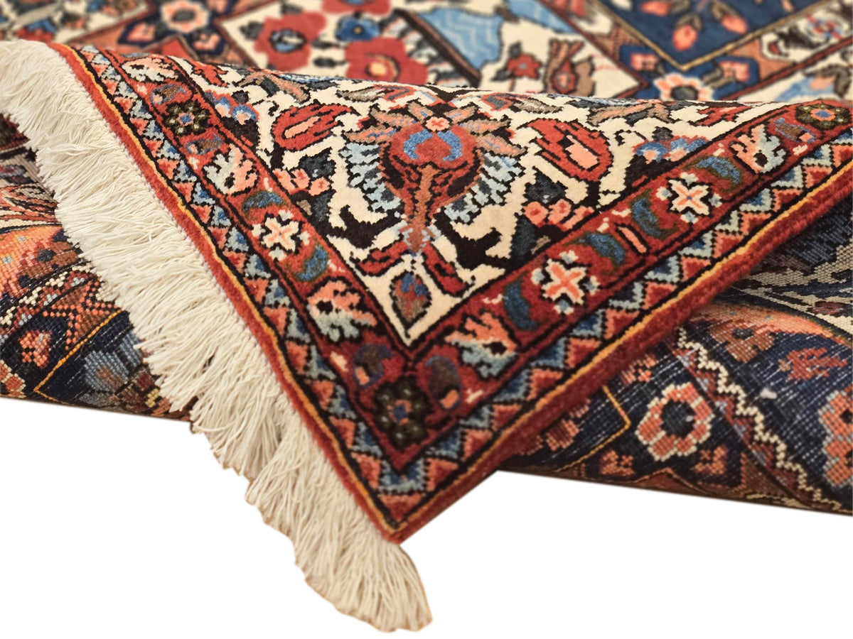 Bakhtiare rug corner close-up with fringe trim and detailed red, blue, cream pattern