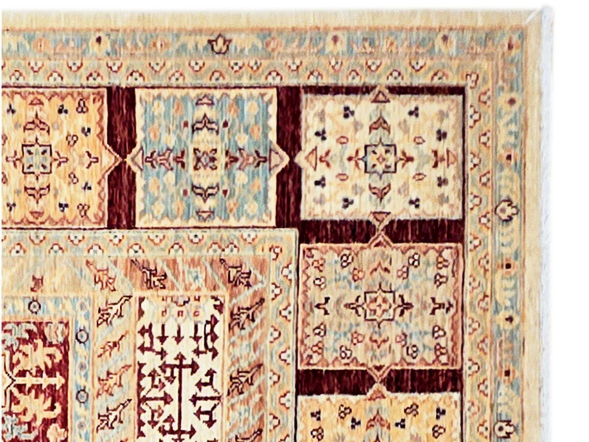 Close-up of Ariana rug border with ornate geometric motifs in red, blue, and beige.