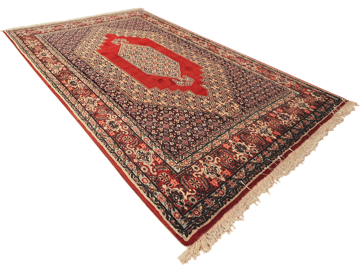 250x142 cm rug with red center panel, dark field, and cream fringe on edges