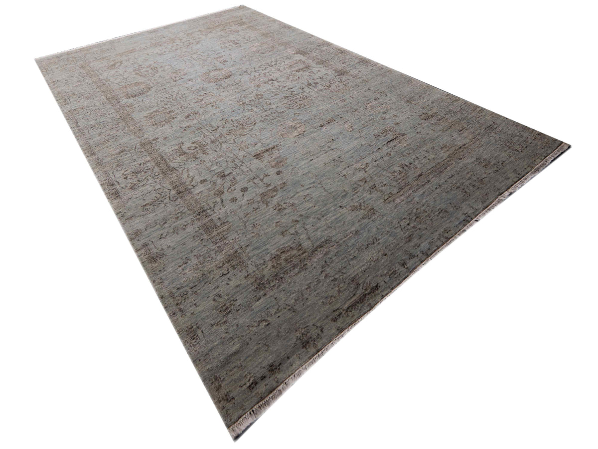 Rectangular light gray distressed area rug with worn, abstract motif