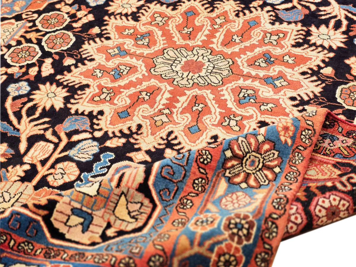 Nahawaand rug close-up of floral and vine pattern in black, orange, blue, and red, dense medallions.